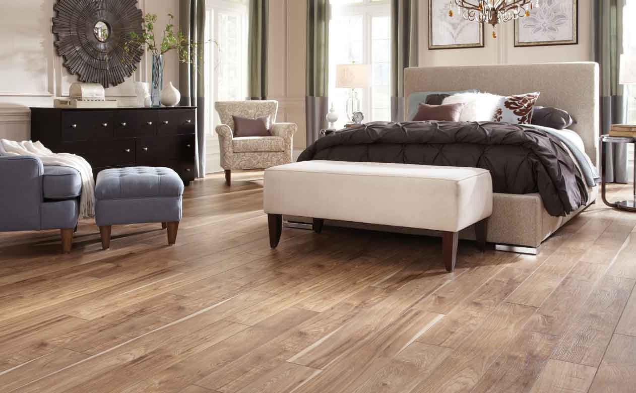 Bedroom with wood look tile flooring 
